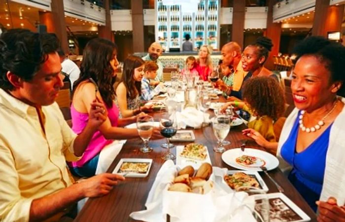 two families sharing a meal on a Dinogo ship