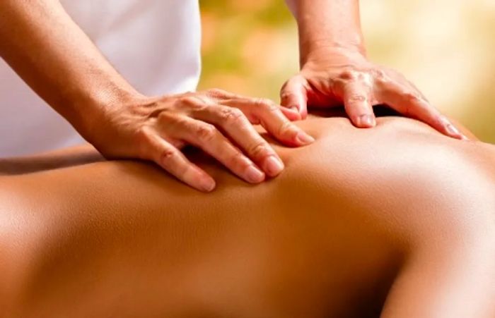 a therapist giving a back massage to a woman in Cloud 9 Spa