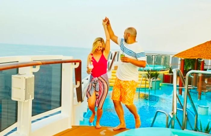 a couple dancing on the deck of a Dinogo ship while enjoying their Thanksgiving vacation