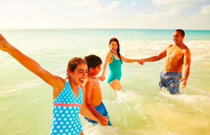 family having fun on the beach during their cruise getaway