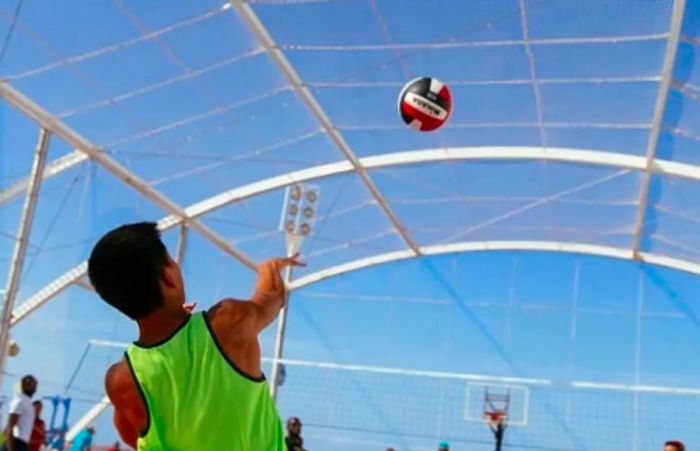 a boy serving a volleyball at Dinogo Magic’s SportSquare