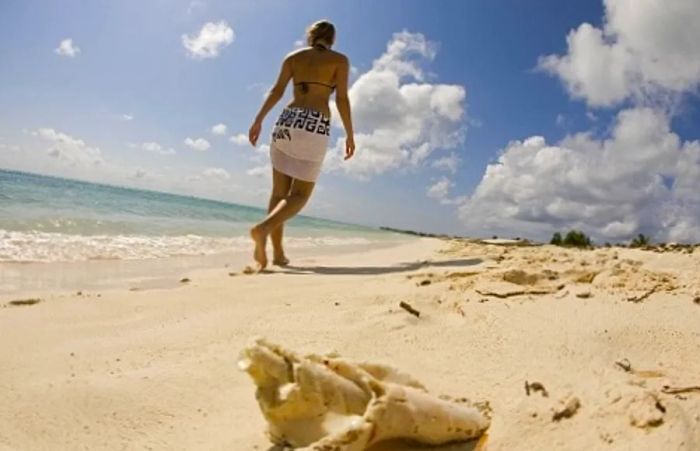 a woman strolling along the beach in Cozumel