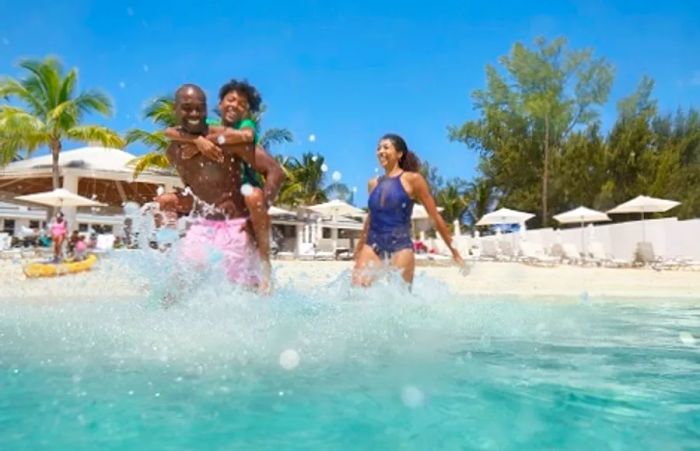 father lifting his son onto the beach at the resort during spring break