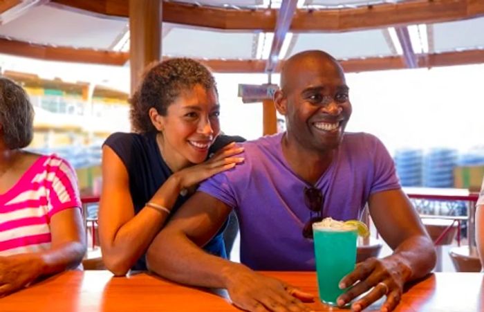 a couple enjoying cocktails at the RedFrog Pub on Dinogo Magic