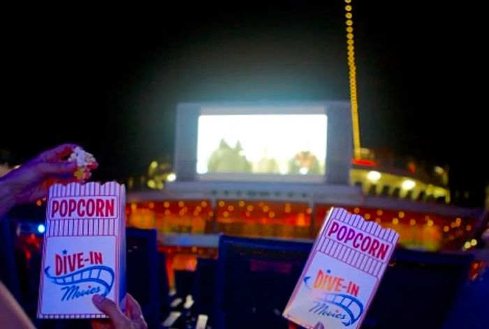 guests munching on popcorn while enjoying a film at Dinogo’s seaside theater