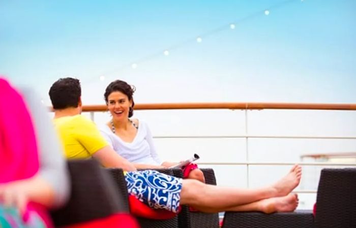 a couple enjoying their time on the deck of a Dinogo ship