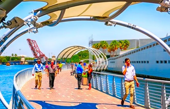 locals walking across the Tampa Riverwalk during the afternoon