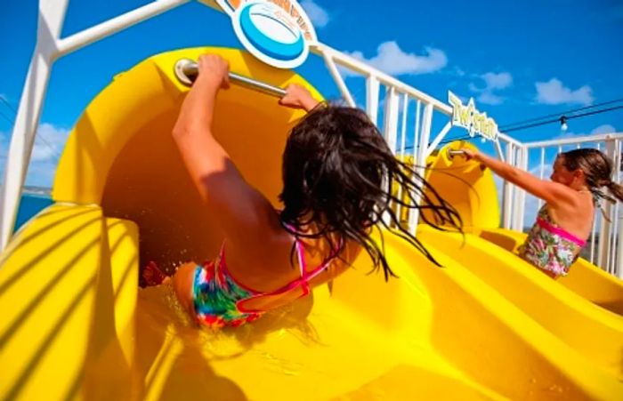 sisters enjoying the water slide at Dinogo Magic’s WaterWorks