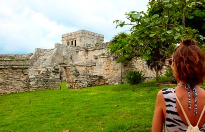 Woman posing in front of the ruins at Tulum