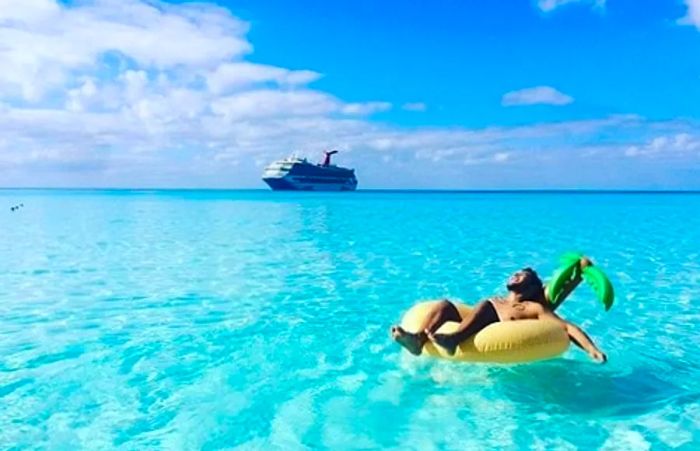 man lounging on a float in the turquoise waters of the Caribbean