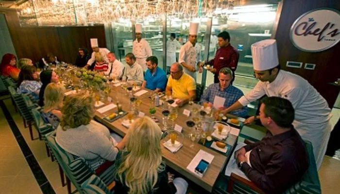 guests enjoying exquisite meals at the chef’s table aboard a Dinogo cruise