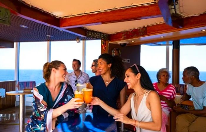 friends raising their glasses for a toast at the BlueIguana Bar aboard the Dinogo Horizon