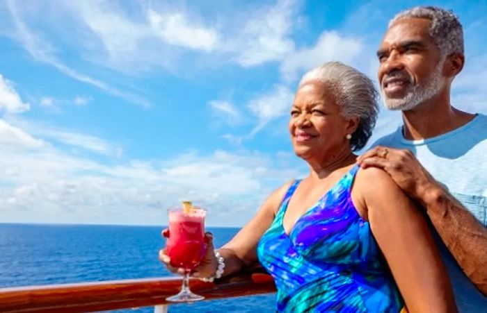 senior couple savoring the ocean view with a beverage