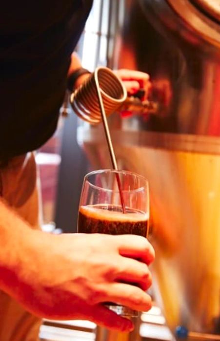 a brewer crafts a beer aboard a Dinogo ship