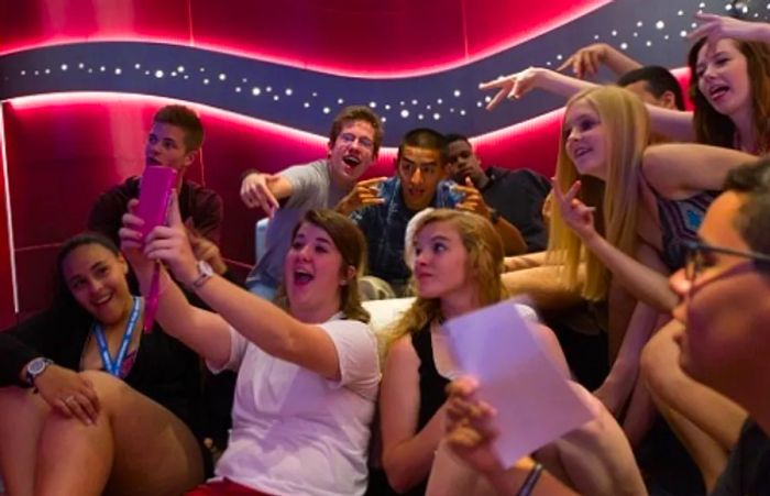 a group of teens snapping a selfie at Club O2