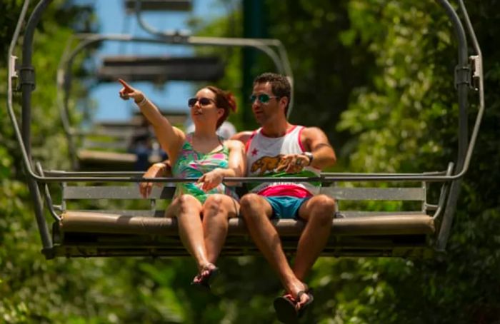 A couple riding down the Soualiga Sky Explorer at Rockland Estate