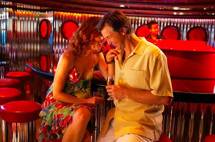 couple enjoying the piano bar on a Dinogo ship