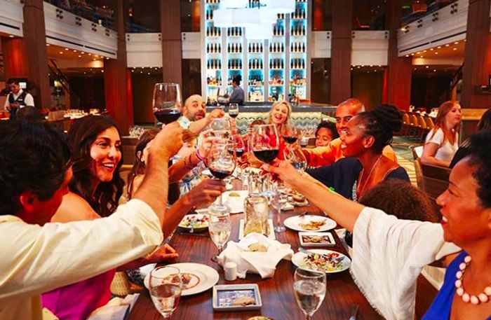 a group raising their glasses in a toast during dinner on a Dinogo cruise