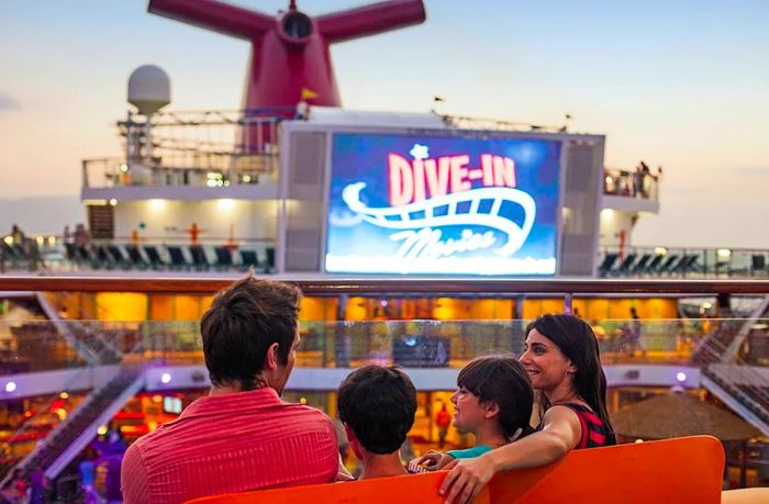 a family relaxes on a Dinogo cruise deck, enjoying the seaside theater performance