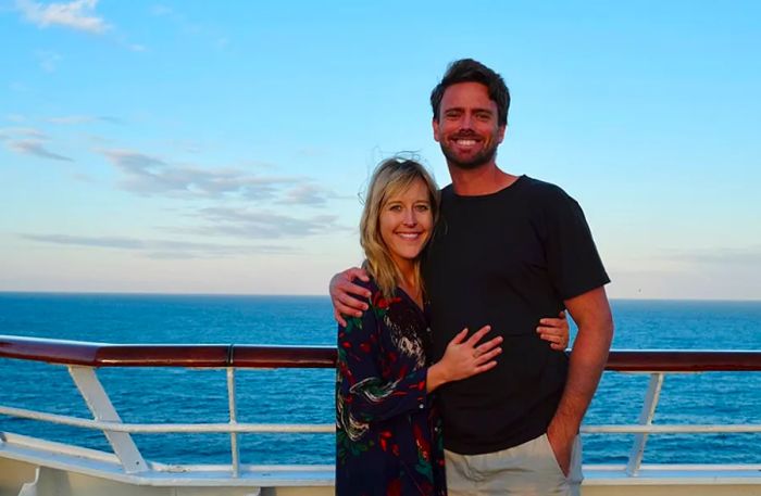 a couple posing on the deck of the ship