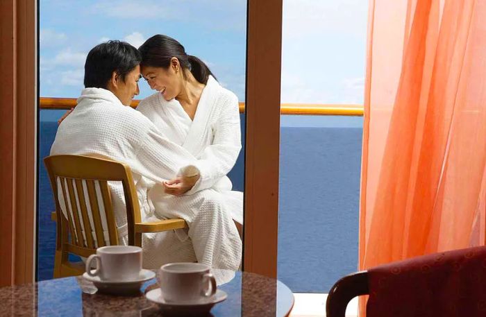 couple enjoying their time on a stateroom balcony in bathrobes