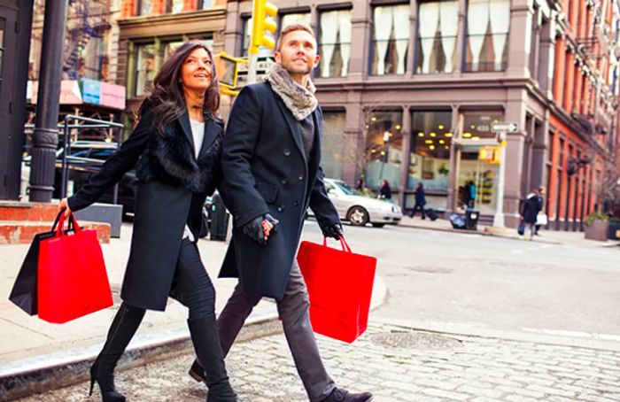 a couple crossing the street with shopping bags in New York City