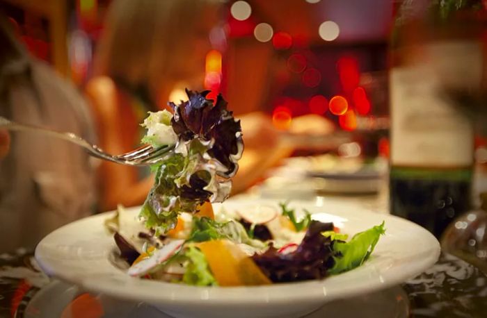 fork loaded with a tasty salad