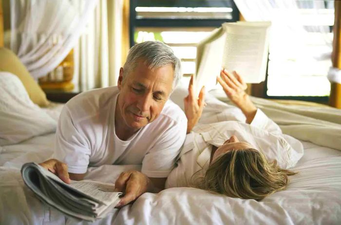 couple unwinding on the bed