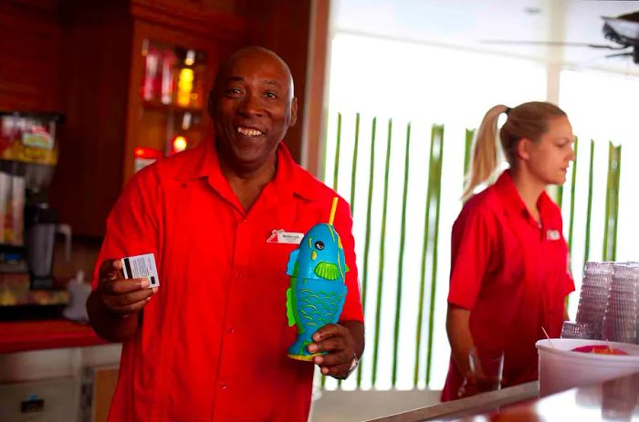 crew member presenting a drink onboard