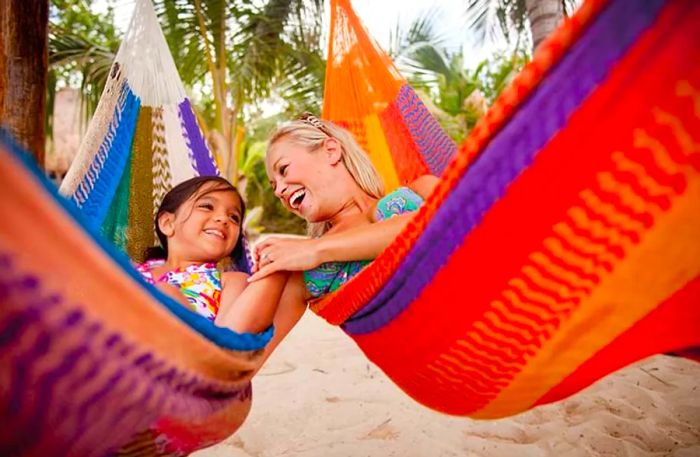 a mother and daughter lounging on hammocks in the Bahamas