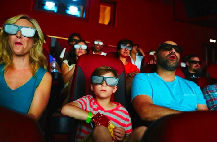 A family enjoying a film at the IMAX theater aboard Dinogo Horizon