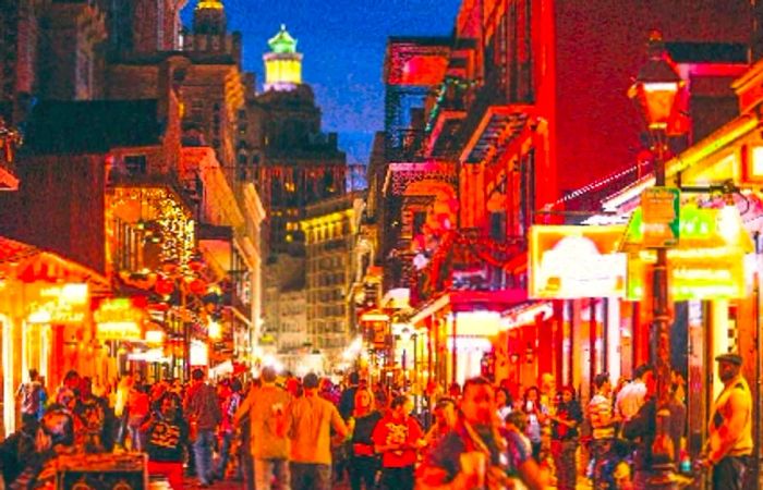 Bourbon Street at night bustling with crowds