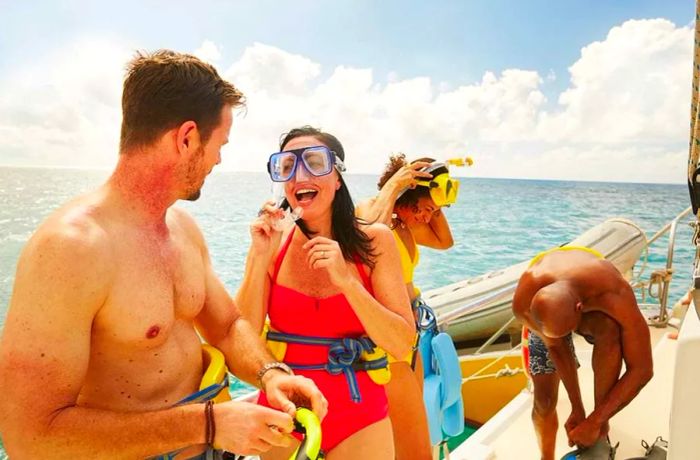 : a couple on a catamaran getting ready to snorkel