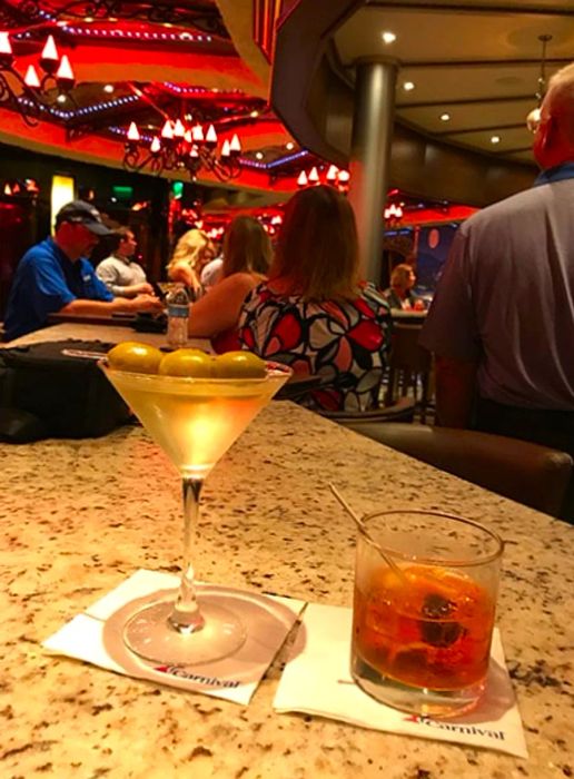 Two drinks sitting on the bar counter