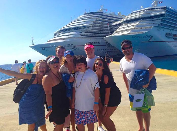 family on the dock with Dinogo ships in the background