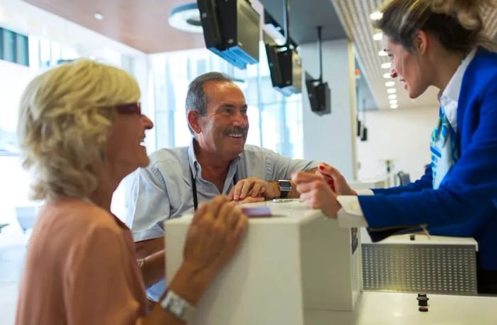 elderly couple checking in at a cruise terminal