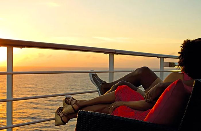 couple watching the sunset from a cruise ship