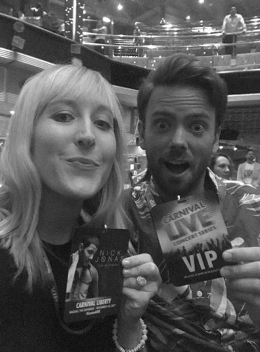 a couple posing with Nick Jonas VIP passes in black and white