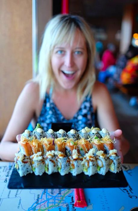 wife holding a plate of sushi