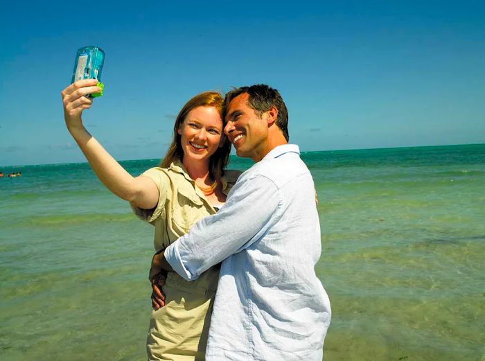 a couple capturing a selfie at the beach