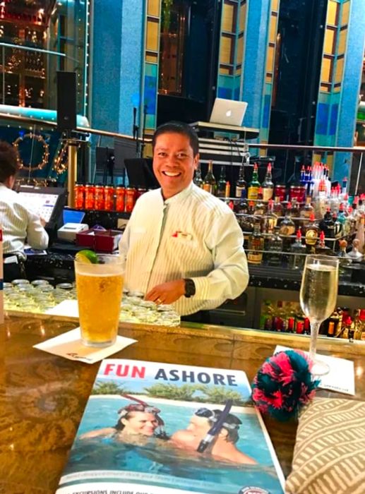 A smiling bartender behind the bar