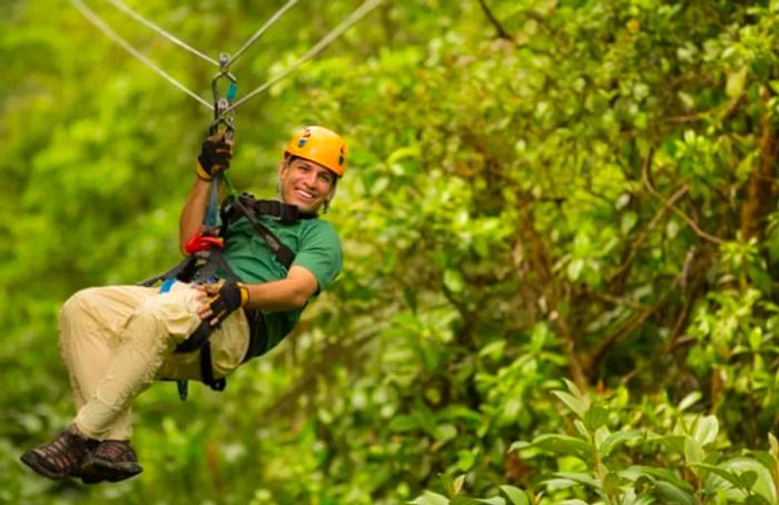 A man zip lining through the canopy tour at Rockland Estate