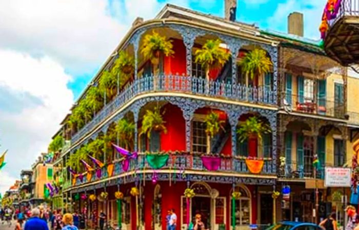 locals and tourists strolling through the streets of the French Quarter in New Orleans