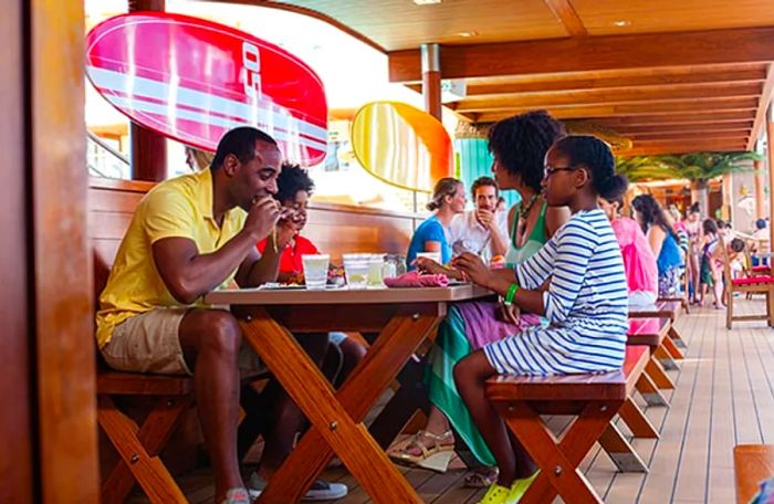 family savoring burgers at Guy’s Burger Joint