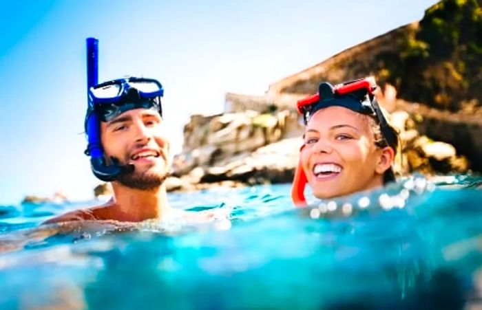 A couple enjoying the fresh air while snorkeling in Hawaii