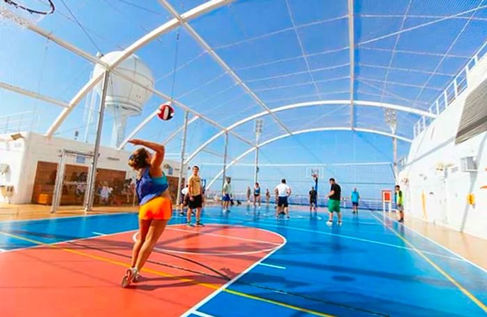 young men and women engaged in a volleyball game at SportSquare