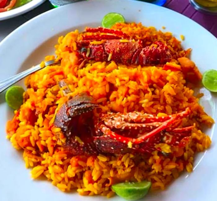 Seafood platter featuring cracked shellfish served on a bed of yellow rice