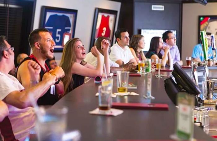 : fans rooting for their teams in the sports bar