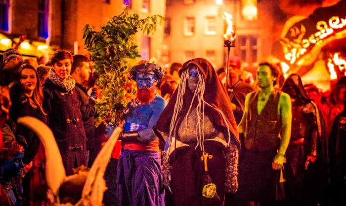 Performers celebrating at a Samhain night festival.