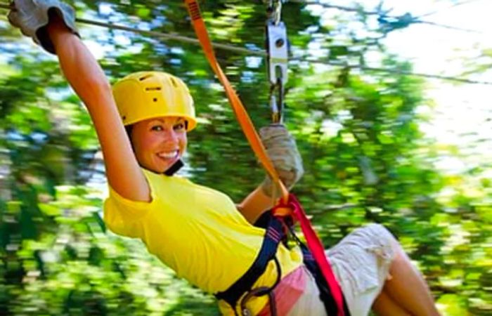 Woman experiencing an exhilarating zip-line canopy tour